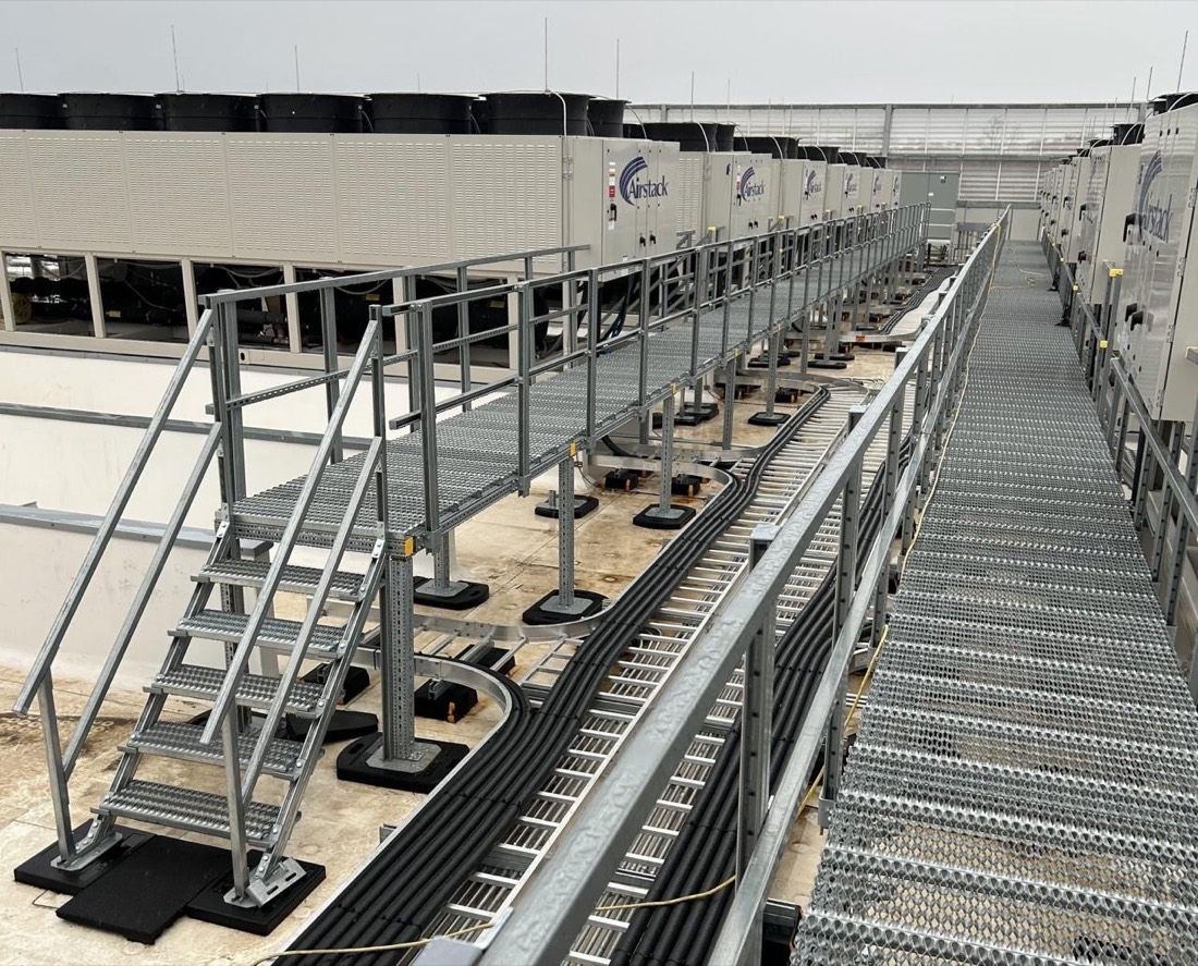 Elevated walkways and stairs over rooftop cable routes